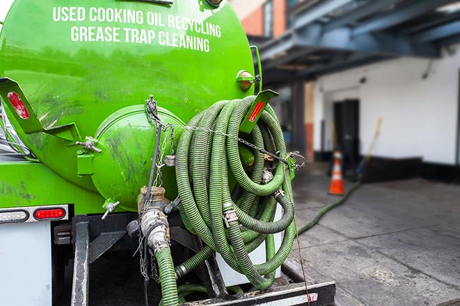 a professional technician pumping a restaurant's grease trap in Beaumont CA